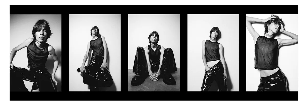 Film strip of five frames of a person in a black mesh top and glossy black trousers, seated and standing poses, white wall