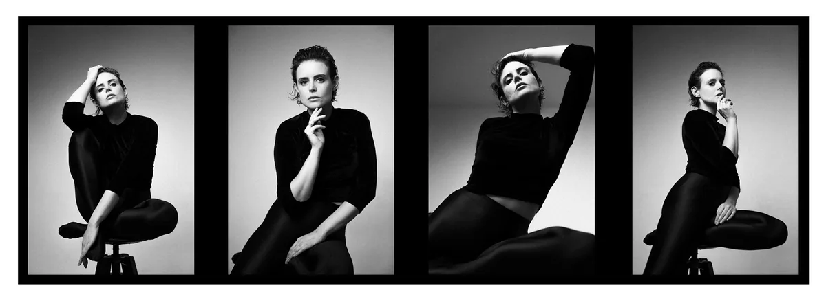 Four frames of a woman in a black top and shiny leggings seated on a stool, one hand raised to her head or chin