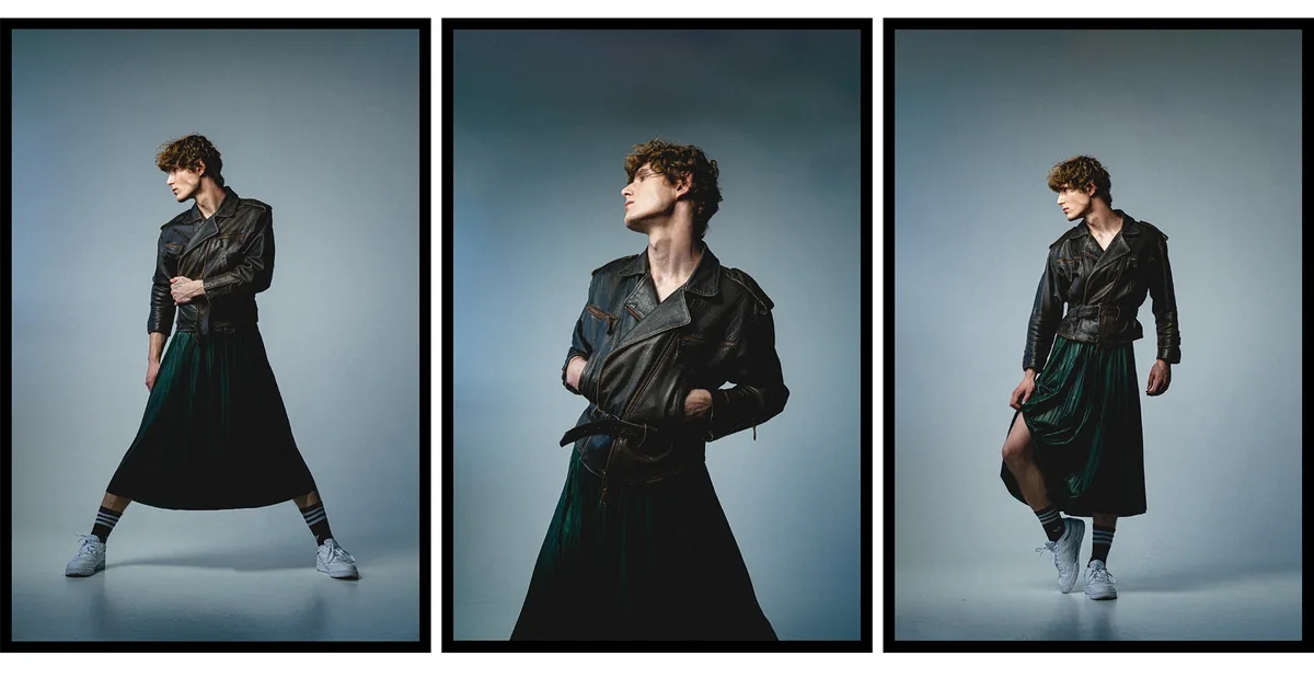 Three poses of a man in a leather biker jacket, green pleated skirt and white sneakers, blue-grey studio backdrop