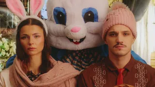 Music video Daria ze Śląska — Plastelina: a woman in bunny ears and a man in a pink beanie beside a giant bunny mascot